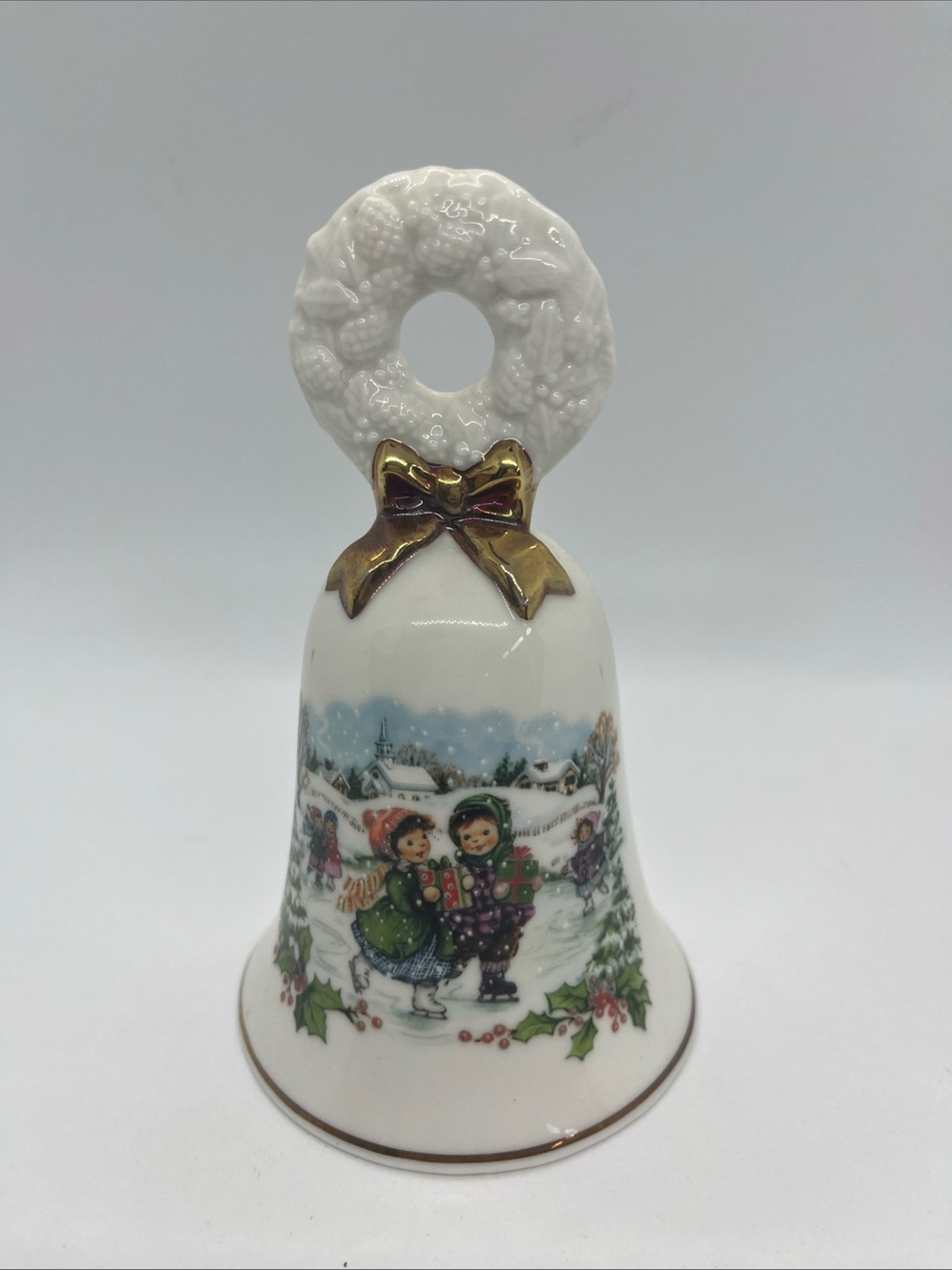 1986 Avon Porcelain Christmas Bell Ice Skating Children with Gold Trim 5 1/4"